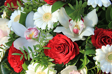 Image showing Cymbidium orchids, red roses and white gerberas