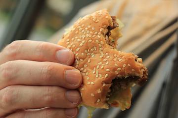 Image showing Man holding a hamburger