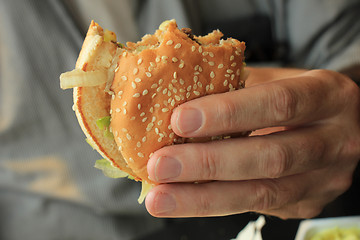 Image showing Man holding a hamburger