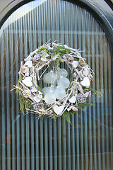 Image showing christmas wreath with decorations on a door