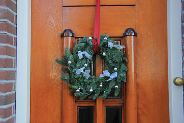 Image showing Classic christmas wreath with decorations on a door