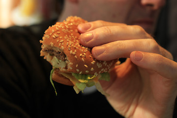 Image showing Man holding a hamburger