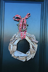 Image showing Classic christmas wreath with decorations on a door