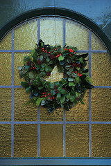 Image showing Classic christmas wreath with decorations on a door