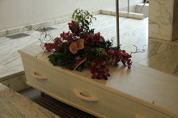 Image showing Coffin with funeral flowers