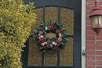 Image showing christmas wreath with decorations on a door