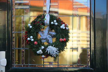 Image showing Classic christmas wreath with decorations on a door