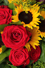 Image showing Red roses and sunflowers in a floral arrangement