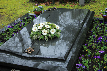 Image showing Funeral flowers on a tomb