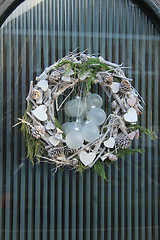 Image showing christmas wreath with decorations on a door