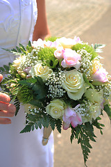 Image showing Bride holding bouquet