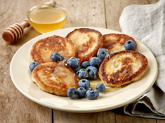 Image showing Pancakes with honey and blueberries