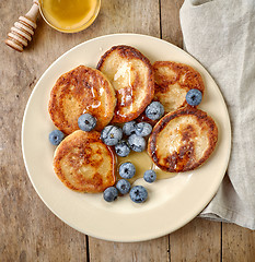 Image showing Pancakes with honey and blueberries