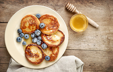 Image showing Pancakes with honey and blueberries