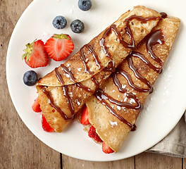 Image showing Crepes with strawberries and chocolate