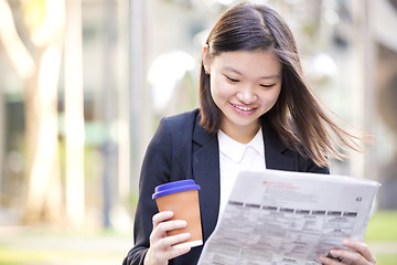 Image showing Young Asian female business executive using laptop