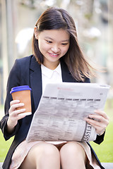 Image showing no captionYoung Asian female business executive using laptop