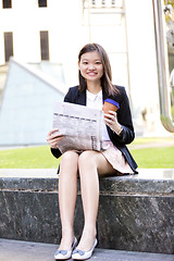 Image showing Young Asian female business executive using laptop