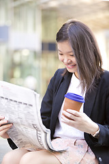 Image showing Young Asian female business executive using laptop