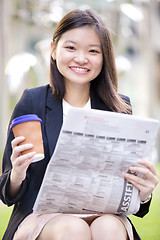 Image showing Young Asian female business executive using laptop