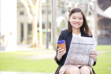 Image showing Young Asian female business executive using laptop