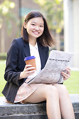 Image showing Young Asian female business executive using laptop