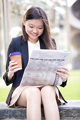 Image showing Young Asian female business executive using laptop