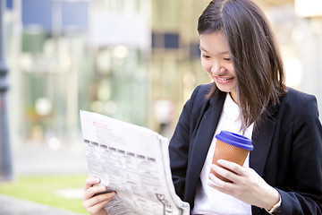 Image showing Young Asian female business executive using laptop