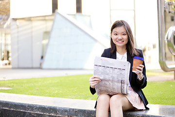 Image showing Young Asian female business executive using laptop