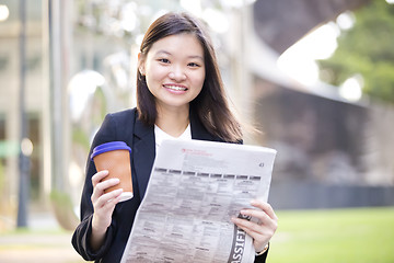 Image showing Young Asian female business executive using laptop