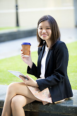 Image showing Young female Asian executive using tablet