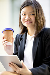 Image showing Young Asian female business executive using tablet