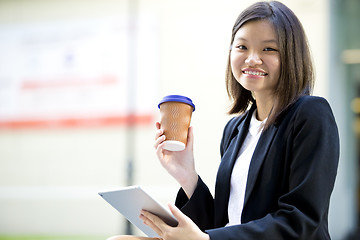 Image showing Young Asian female business executive using tablet