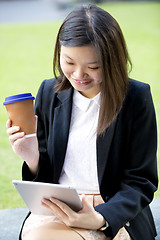 Image showing Young Asian female business executive using tablet