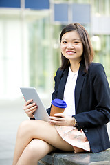 Image showing Young Asian female business executive using tablet