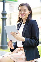 Image showing Young Asian female business executive using tablet