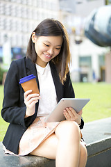 Image showing Young Asian female business executive using tablet