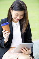 Image showing Young Asian female business executive using tablet