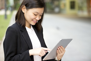 Image showing Young Asian female business executive using tablet