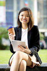 Image showing Young Asian female business executive using tablet