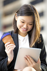 Image showing Young Asian female business executive using tablet