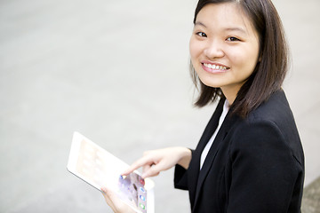 Image showing Young Asian female business executive using tablet