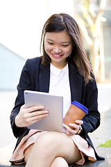 Image showing Young Asian female business executive using tablet