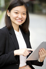 Image showing Young Asian female business executive using tablet