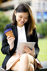 Image showing Young Asian female business executive using tablet