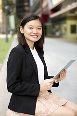 Image showing Young Asian female business executive using tablet