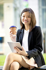 Image showing Young Asian female business executive using tablet