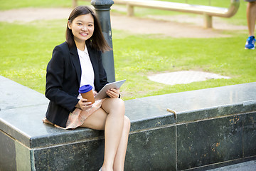 Image showing Young Asian female business executive using tablet