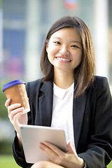 Image showing Young Asian female business executive using tablet