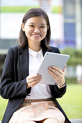 Image showing Young Asian female business executive using tablet